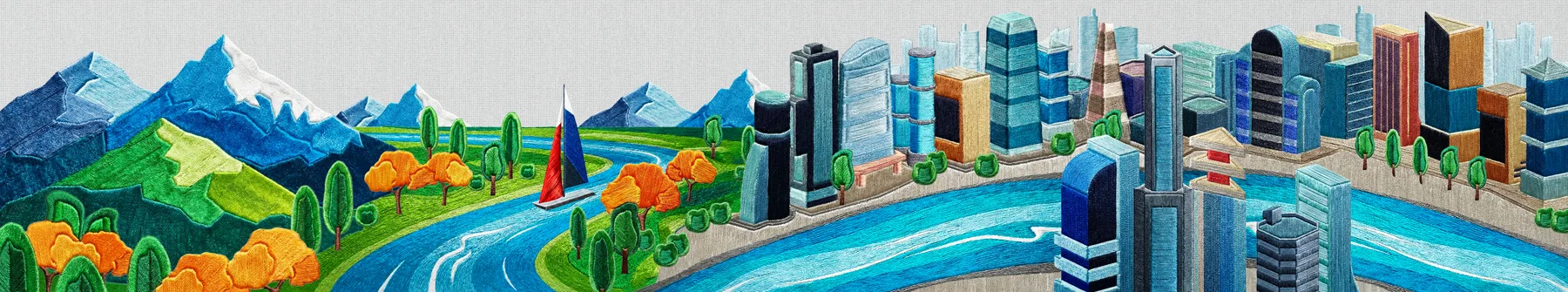 A river running from green mountains into a connected city skyline