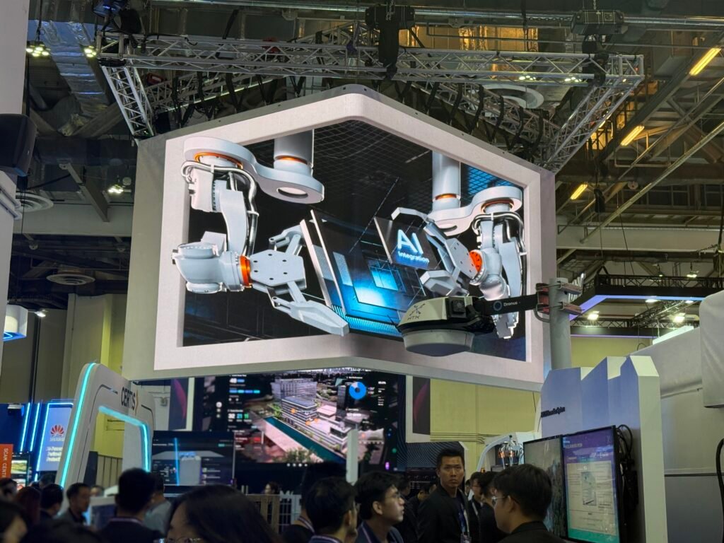 Alt Text: 3D anamorphic CGI robotic arms with AI integration visual on L-shaped LED screen at Certis booth, Milipol TechX 2026