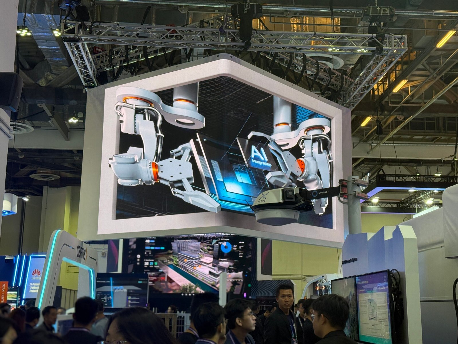 Alt Text: 3D anamorphic CGI robotic arms with AI integration visual on L-shaped LED screen at Certis booth, Milipol TechX 2026