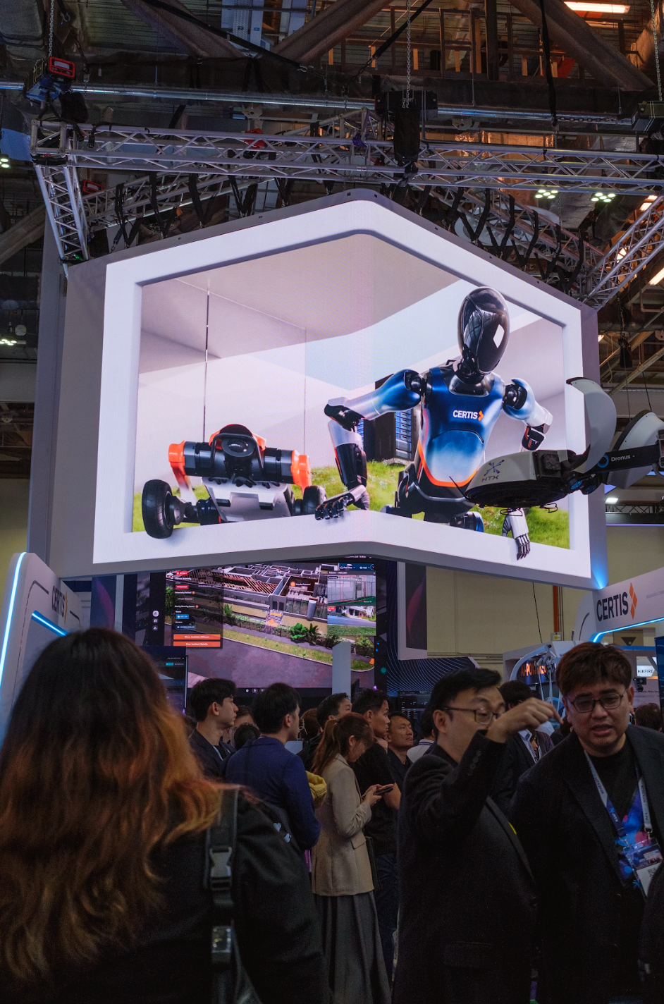 Alt Text: 3D anamorphic display at Certis booth, Milipol TechX 2026, showing CGI robots on an L-shaped LED screen 